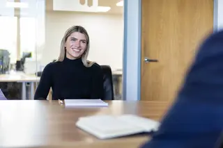 Photo of team member sat at desk