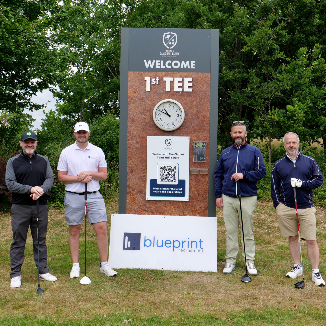 4 men playing golf